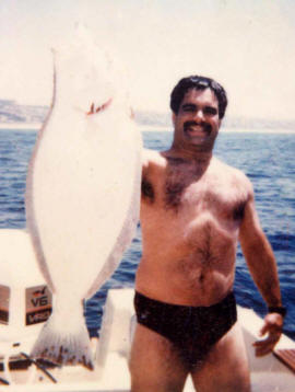 Stephen Speregen holding up Large Halibut white side showing